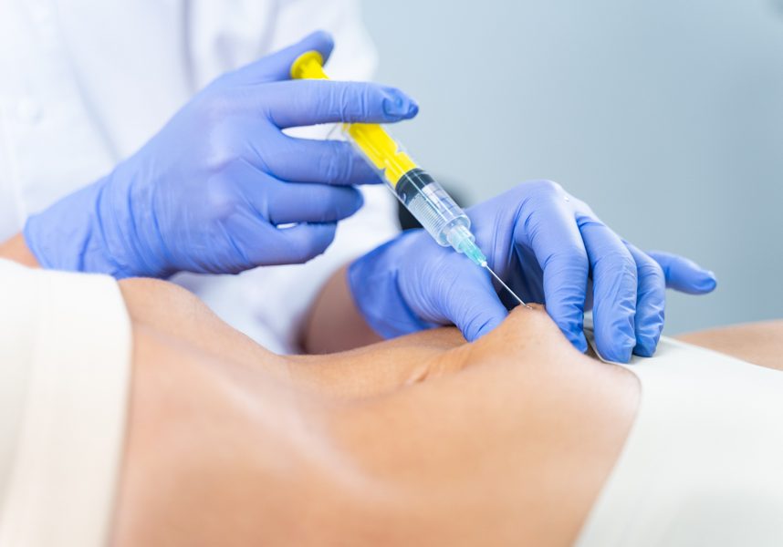 Woman receiving a belly injection for figure correction Cropped photo of a female patient getting rid of unwanted fat deposits in the problem area
